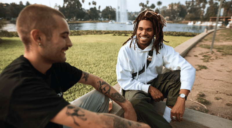 two men sitting in a park.